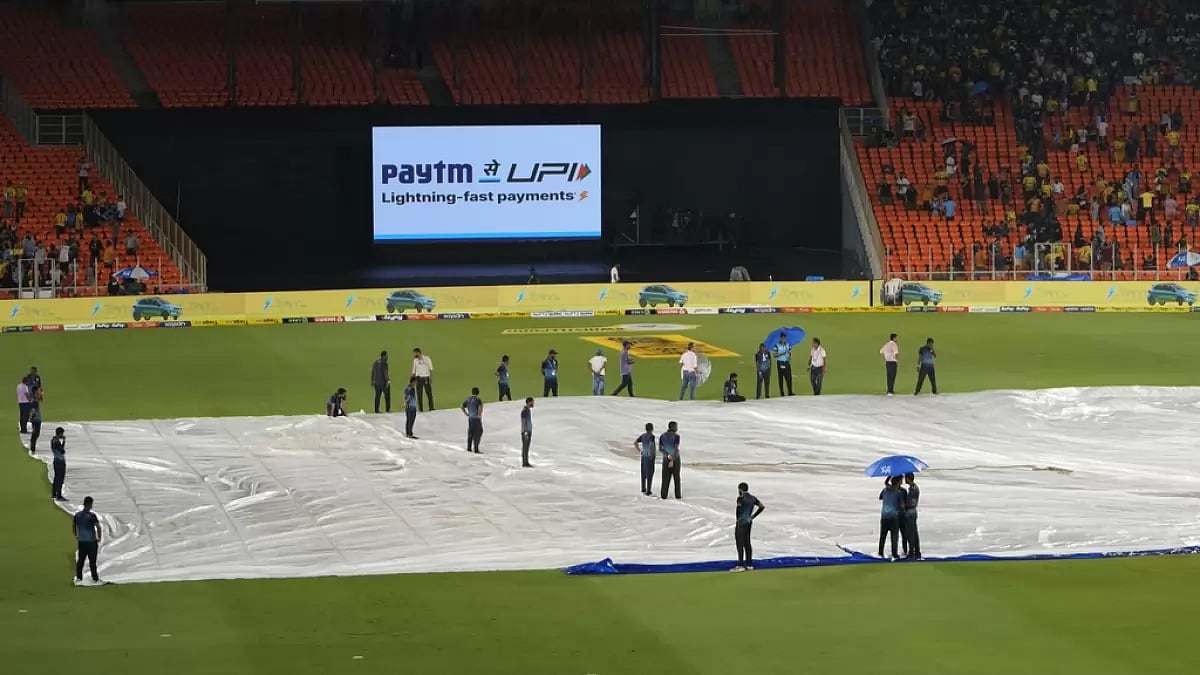 The pitch at the Narendra Modi Stadium covered due to rain. - AP