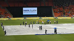 AP : The pitch at the Narendra Modi Stadium covered due to rain.