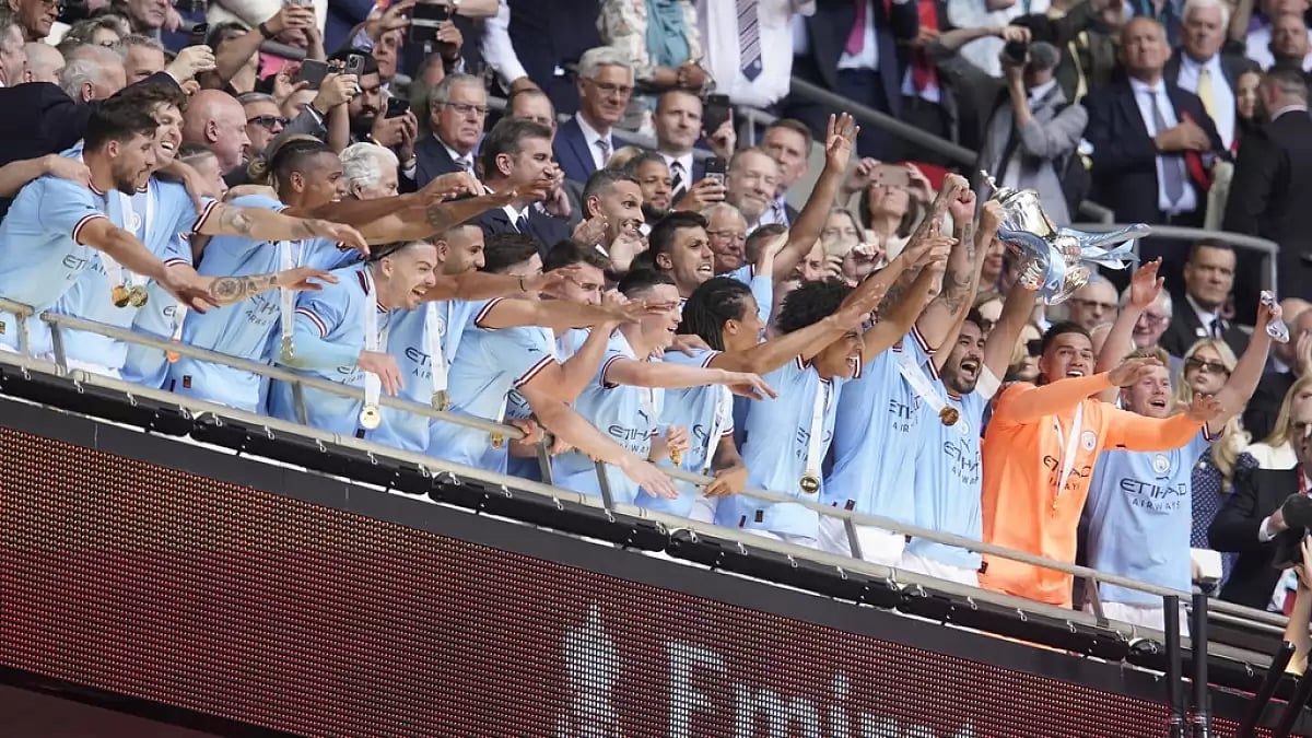 City's Gundogan lifts the winner's trophy at Wembley Stadium on Saturday.