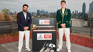 India's Rohit Sharma and Australia's Pat Cummins (L) pose with the WTC mace.