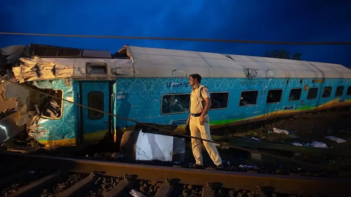 A police man maintains vigil near the wreckage of three trains that crashed on June 2 in Bahanaga village in Balasore district, Odisha.
