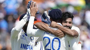Siraj, right, celebrates the run-out of Mitchell Starc with Axar Patel in London on Thursday.