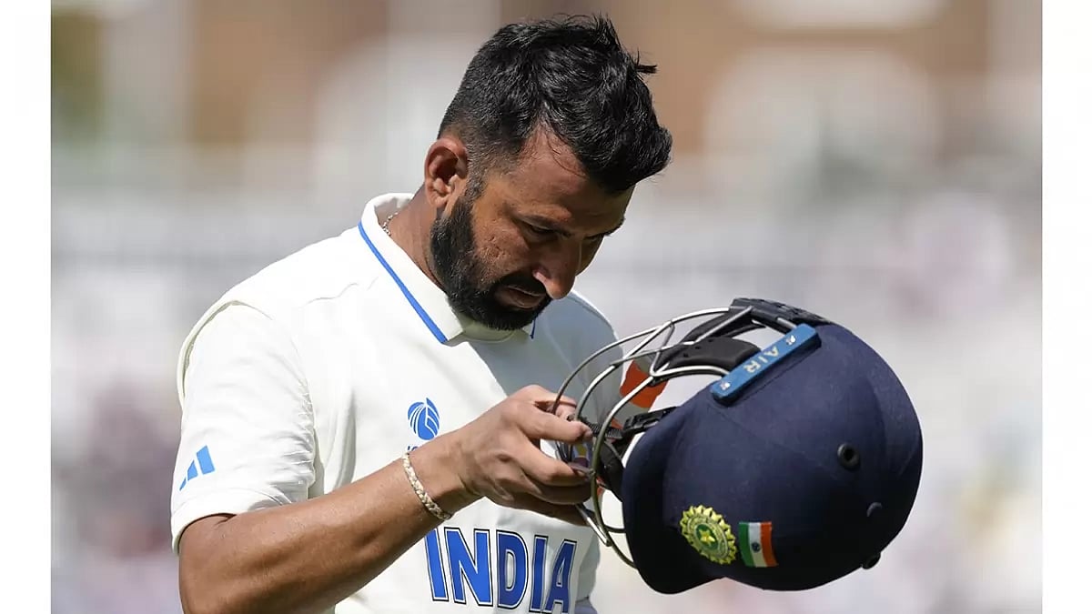 India's Cheteshwar Pujara walks back to the pavilion at The Oval.