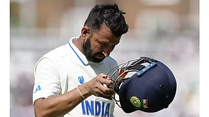 India's Cheteshwar Pujara walks back to the pavilion at The Oval.