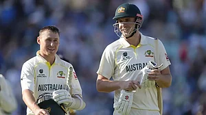 Labuschagne, left, and Green leave the pitch after Stumps on Day 3 in London on Friday.