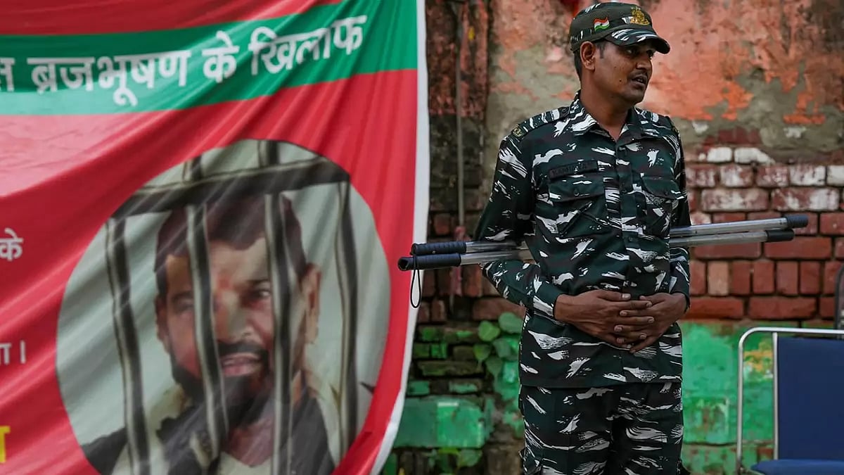 A security personnel guards during wrestlers' protest against Wrestling Federation of India (WFI) chief Brij Bhushan Sharan Singh, near Jantar Mantar in New Delhi. - null