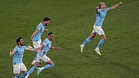 Manchester City players run in ecstasy as they clinch the UCL title against Inter.
