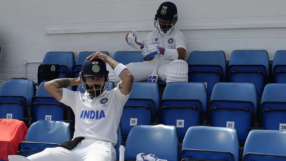India's Virat Kohli (front) and teammate Ajinkya Rahane wait for the start of play on the fifth day of the 2023 ICC World Test Championship final between India and Australia at The Oval cricket ground in London.