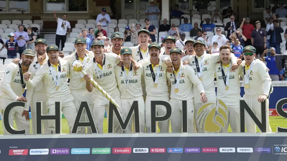 Skipper Pat Cummins holds the ICC mace as his team celebrates