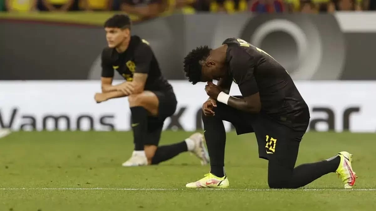 Vinicius takes a knee ahead of Brazil's match against Guinea on Saturday.