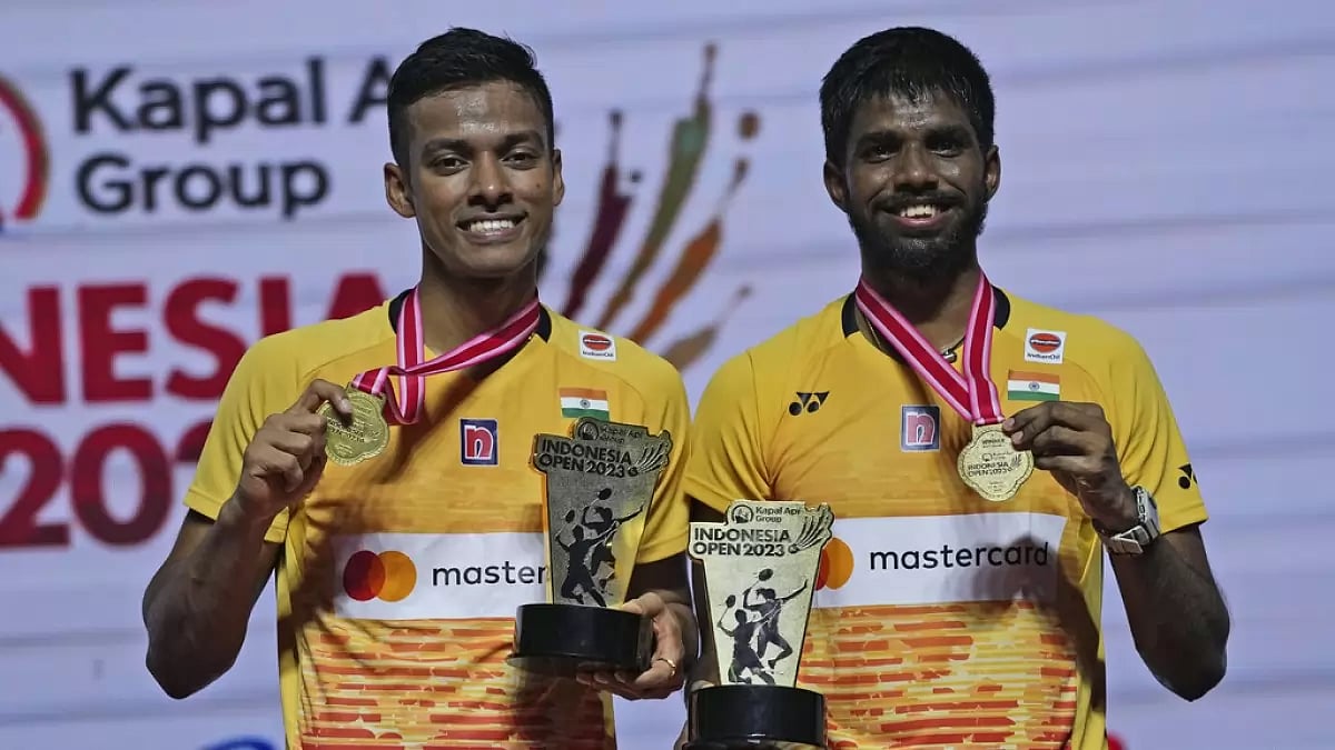 Chirag, left, and Satwik celebrate with their medals and trophies in Jakarta.