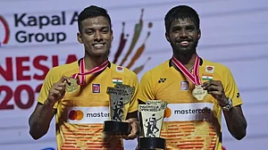 Chirag, left, and Satwik celebrate with their medals and trophies in Jakarta.