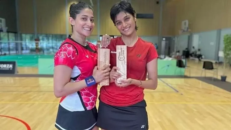 Ashwini Ponnappa, left, and Tanisha Crasto pose with their title. - null