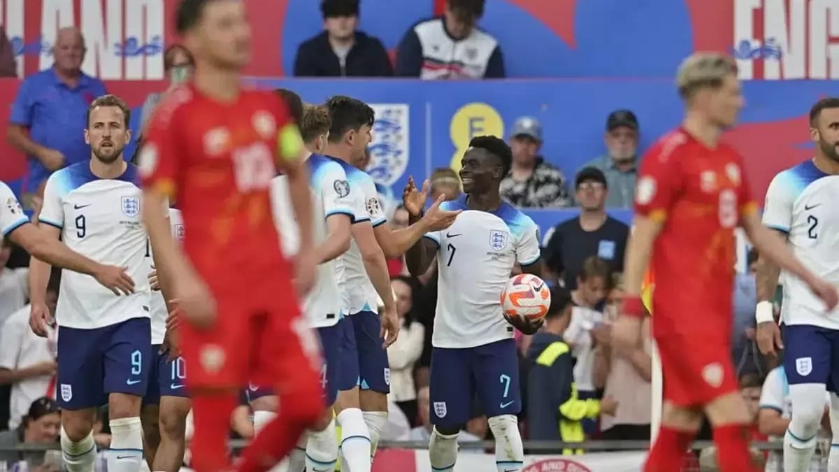 England players congratulate Bukayo Saka (C) after the forward scored a hat-trick.