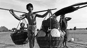 How Poor is Poor?: An Adivasi family in search of work, seen here travelling with their child and belongings in Bastar, Chattisgarh, 1995