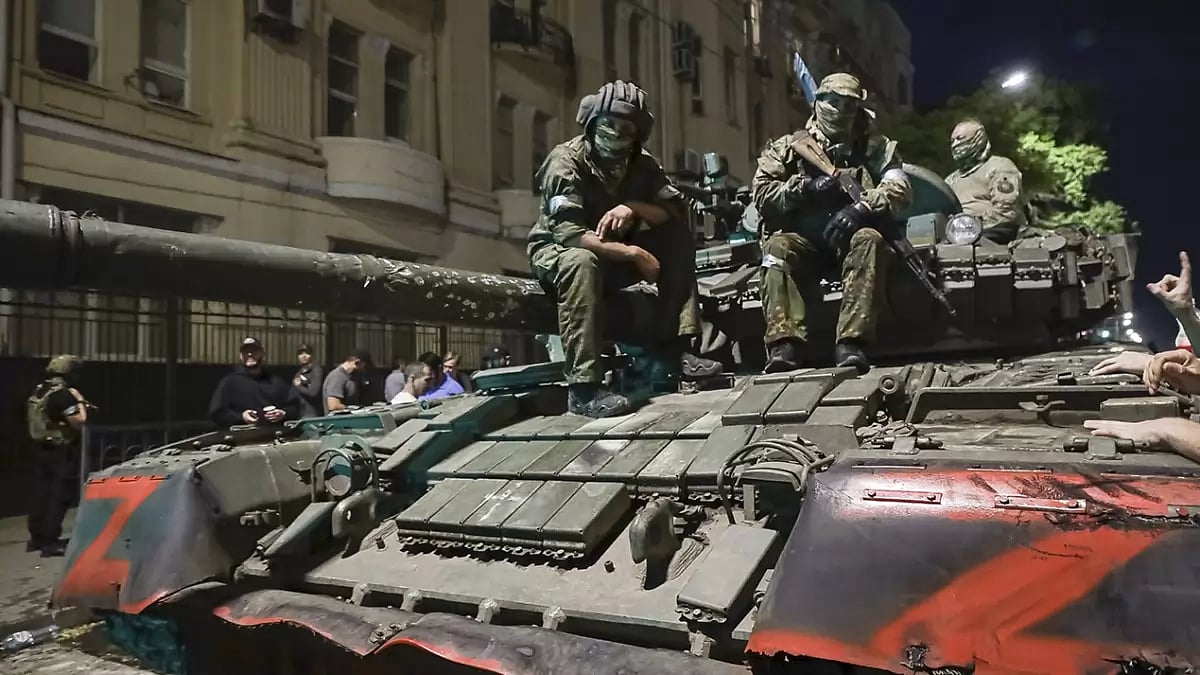 Membes of the Wagner Group military company sit atop of a tank on a street in Rostov-on-Don, Russia prior to leaving an area at the headquarters of the Southern Military District.