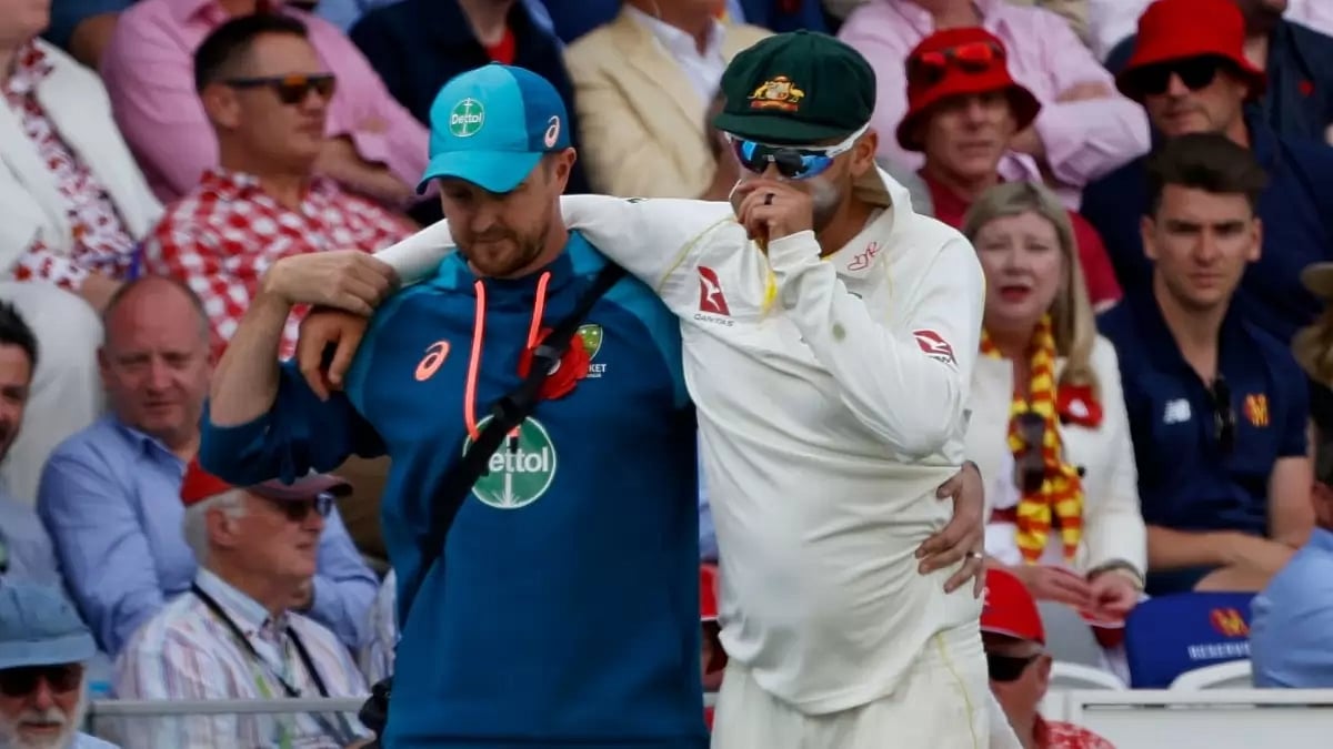 Nathan Lyon walks off the field with a calf problem.