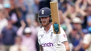 Ben Stokes raises his bat after reaching the triple-figure mark at Lords.