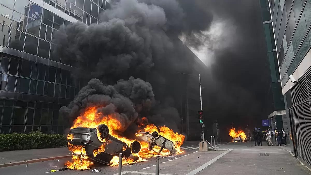 Cars burn after a march for Nahel in Nanterre, outside Paris.