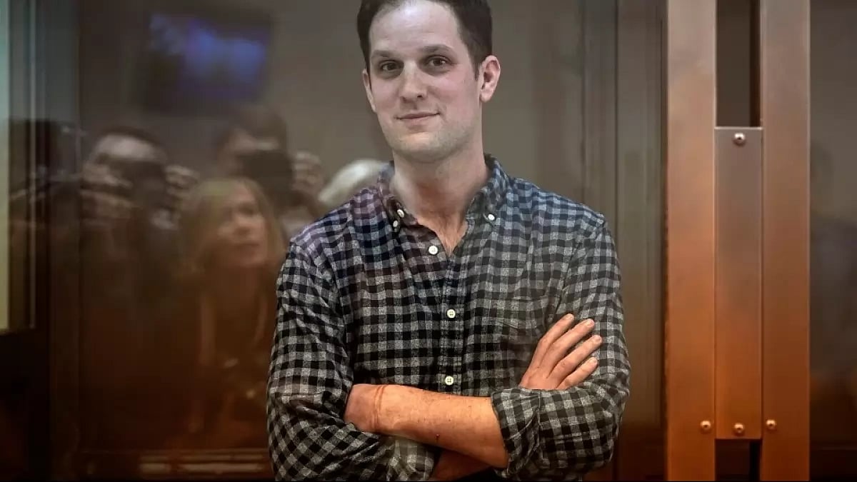 Wall Street Journal reporter Evan Gershkovich stands in a glass cage in a courtroom at the Moscow