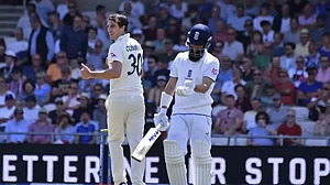 Cummins, left, celebrates the dismissal of Moeen Ali at Leeds on Friday.
