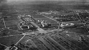 An aerial view of government buildings in Old Delhi, India, circa 1935. On the left are the north and south blocks of the Secretariat Building with the Rashtrapati Bhavan (presidential Palace) in the background. On the right is the circular Indian Parliament (Sansad Bhavan).
