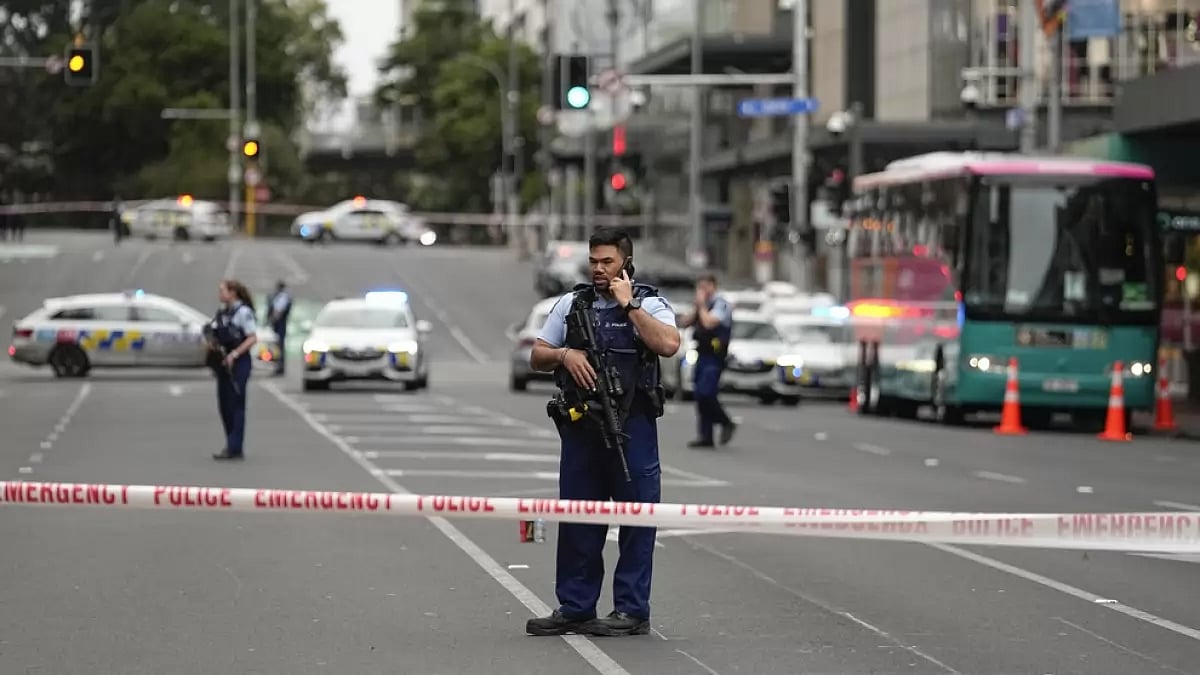 Armed police officers stand at a road block in the central business district following a shooting in