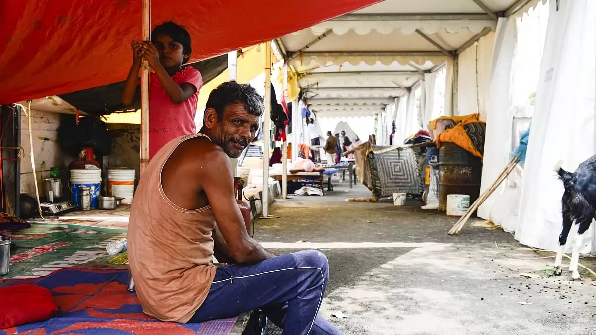 A father and a daughter inside a relief camp at Bela Estate