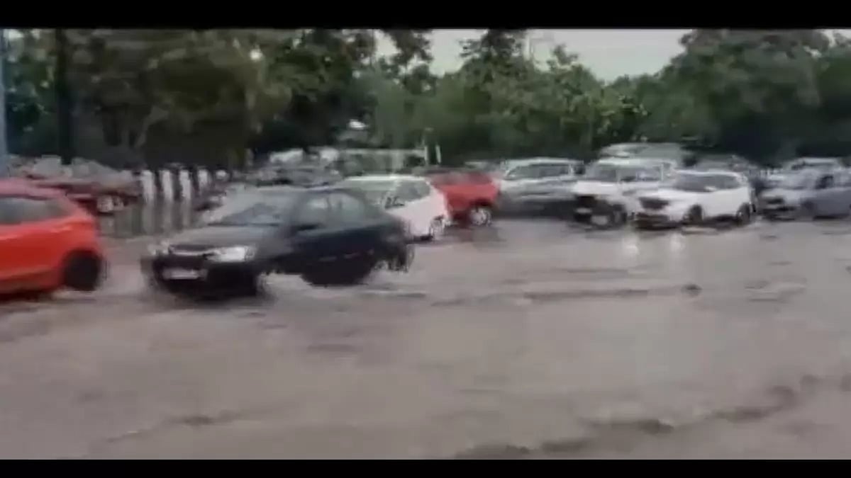 Cars pass through inundated roads in Noida.