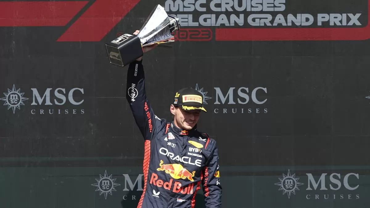Max Verstappen celebrates with his trophy on the podium at the Belgian GP