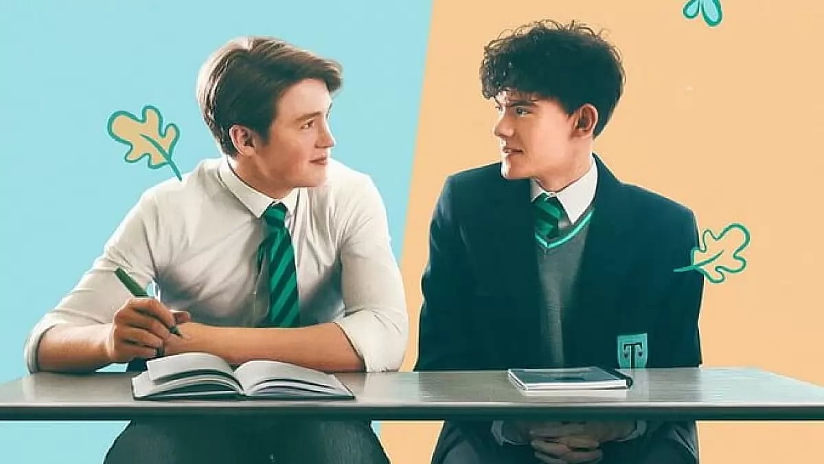 The lead characters are sitting in front of a table, looking into each other’s eyes romantically.