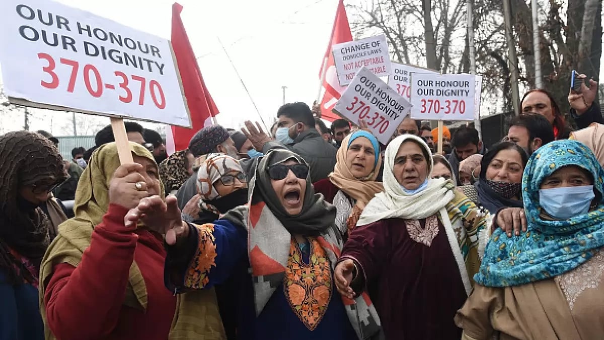 Activists of National Conference shout slogans and hold placards during a protest in Srinagar, Jammu and Kashmir.