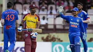 Indian players celebrate the wicket of Nicholas Pooran.