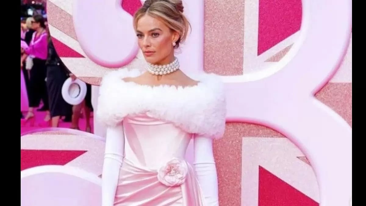 Margot Robbie posing for “Barbie” at a promotional event