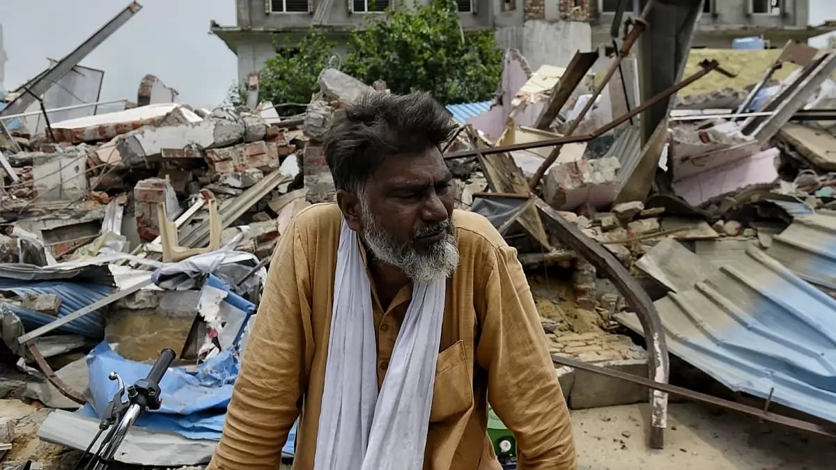 Nawab crying in front of one of his shops outside the medical college in Nuh that was demolished by the authorities.