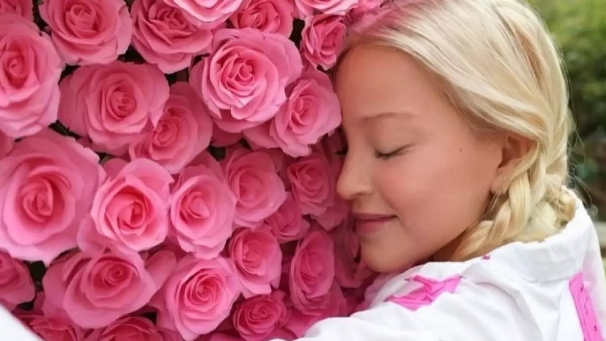 Madonna posing while embracing a bed of roses 