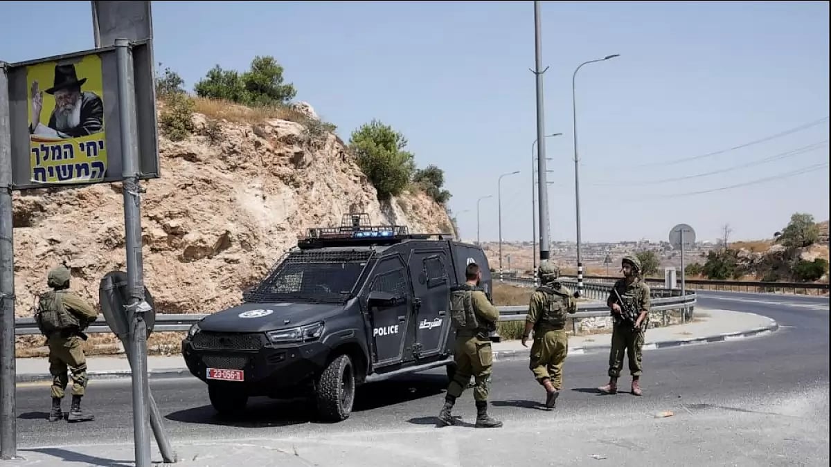 Israeli forces work at the site of a shooting attack near the West Bank city of Hebron, Monday, Aug.