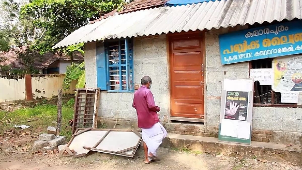 Librarian P Sukumaran enters the Kumarapuram Public Library in Karuvatta, Alappuzha district, Kerala