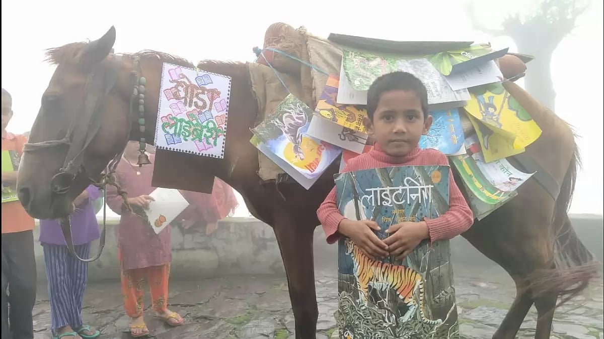Horse Library: A hose carrying books on its back while a child stands.
