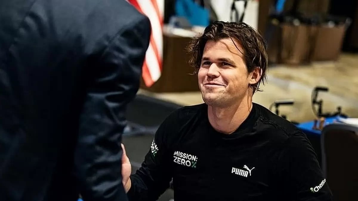 A smiling Carlsen exchanges notes with Praggnandhaa during the final 