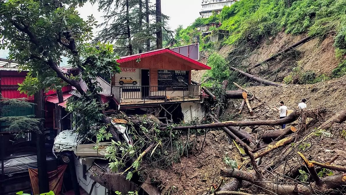 A house partially buried under debris following a landslide after heavy rainfall, in Shimla