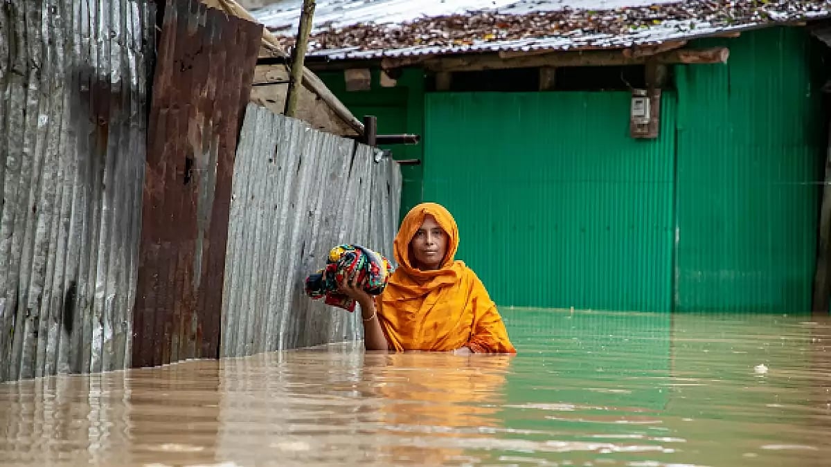 A Pedestrian walks through flooded roads in South Chittagong, Bangladesh, in high-level water.