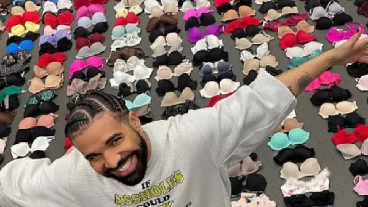 Drake smiles ear to ear, posing with his brassiere collection 