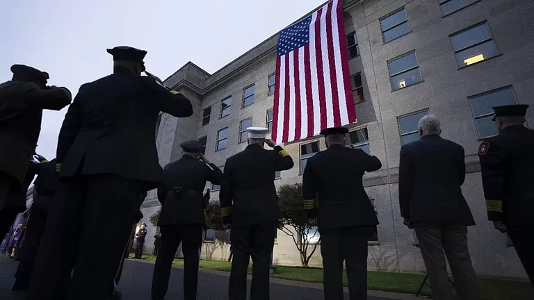 First responders salute as an American flag is unfurled at the Pentagon - null