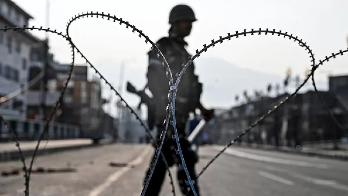 A paramilitary trooper stands guard on a road in Srinagar.