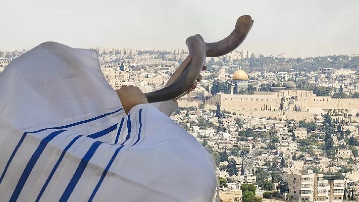 A person blows the shofar.