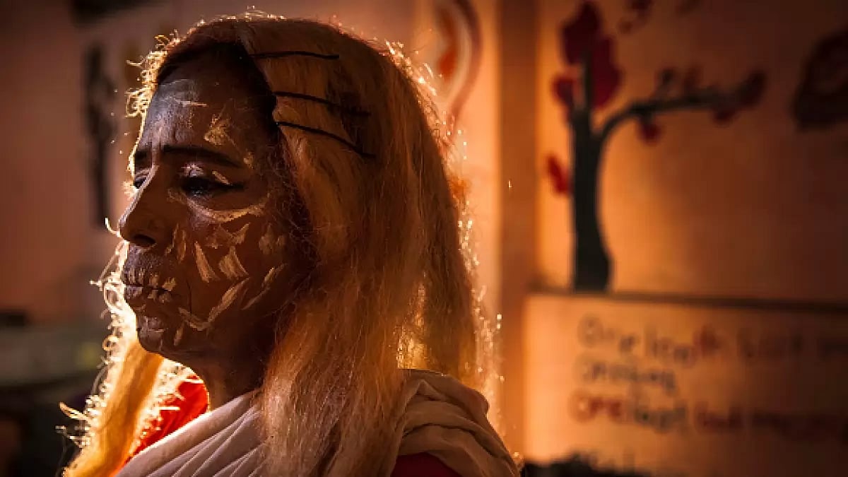 A Jatra performer waits to go onstage during an outdoor performance in Kolkata.