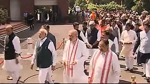 PM Narendra Modi leads the rest of the ministers as they walk into the new Parliament building.