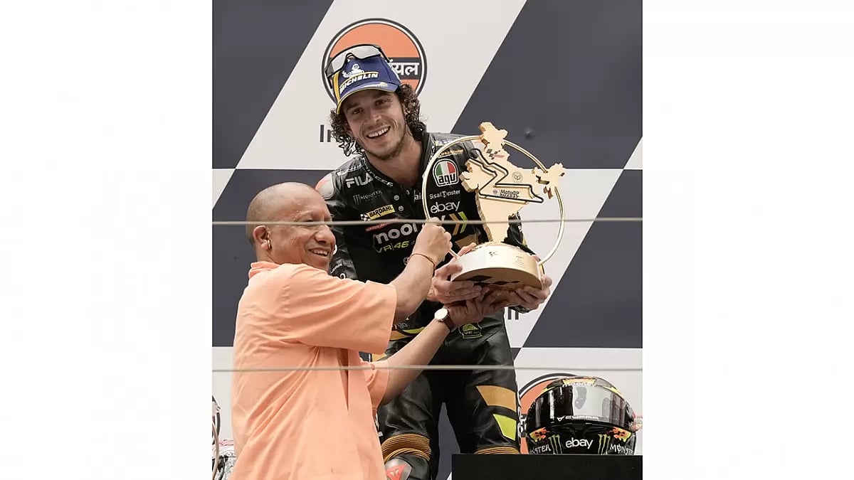 Uttar Pradesh Chief Minister Yogi Adityanath presents the winning trophy to Mooney VR46 Racing Team (Ducati) team Italian rider Marco Bezzecchi during the presentation ceremony of  MotoGP race, at the Grand Prix of India, Buddha International Circuit, Greater Noida.