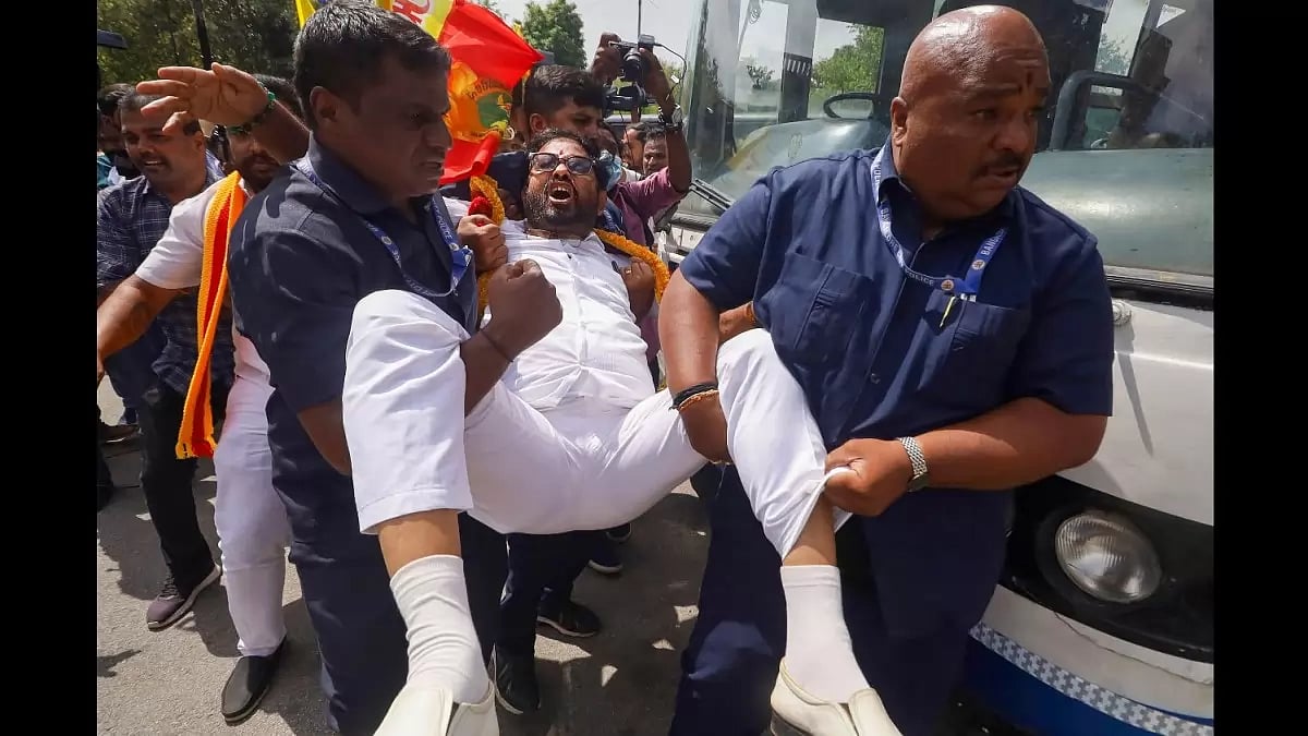 Police personnel detain an activist protesting during a 'bandh' called by farmers